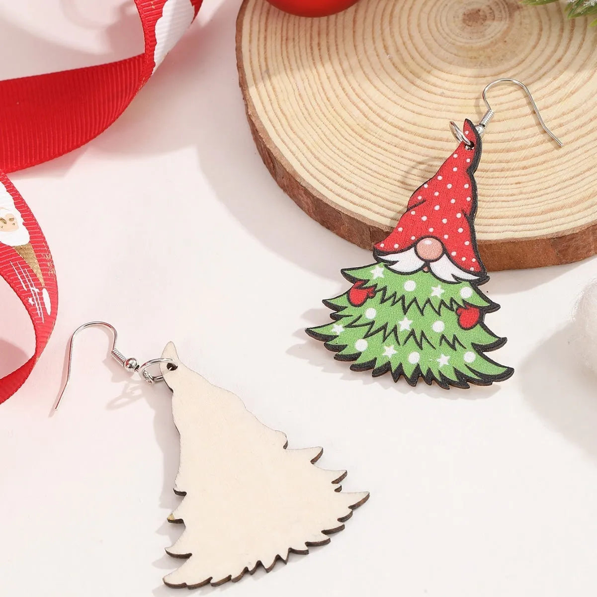 Wooden Christmas earrings with geometric tree and snowman designs featuring Santa Claus elements