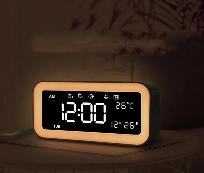 Blue rectangular LED digital alarm clock with multicolour light settings on a wooden surface.