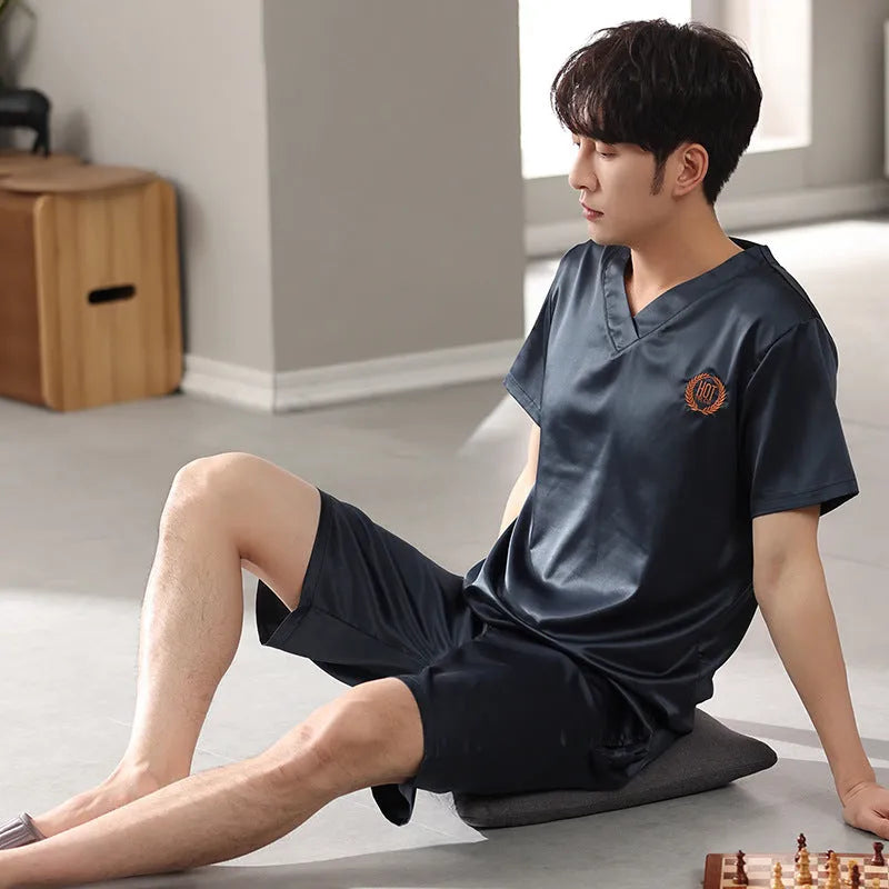 Man's light blue ice silk short-sleeve pajama shirt and loose matching shorts laid flat