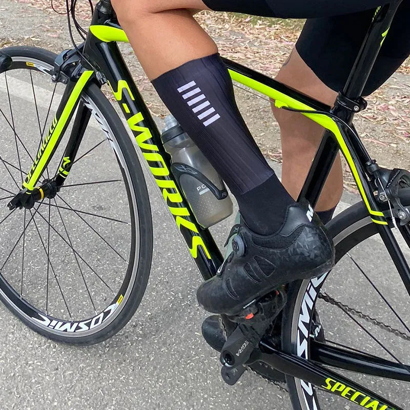 Cycling socks in chemical fibre blend fabric shown in orange, black, purple, white, grey and dark blue colour options