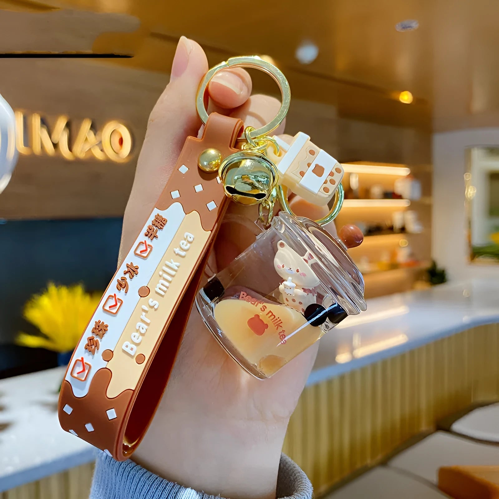 Oil-infused pearl milk tea bear keychain pendant in clear acrylic with alloy ring, featuring a drink bottle style design