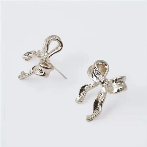 Gold bow earrings simple style alloy electroplated finish pair on white background
