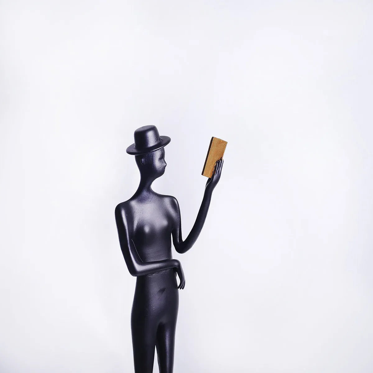 Black cast aluminum modern character desktop sculpture measuring 51cm tall.