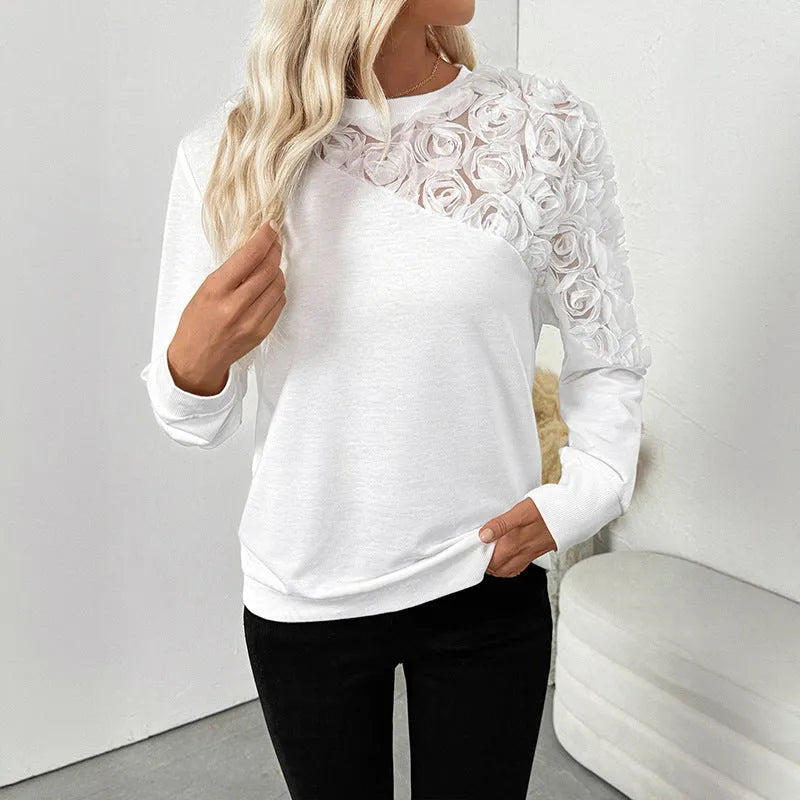 White long sleeve women's blouse with floral pattern, loose fit pullover style.