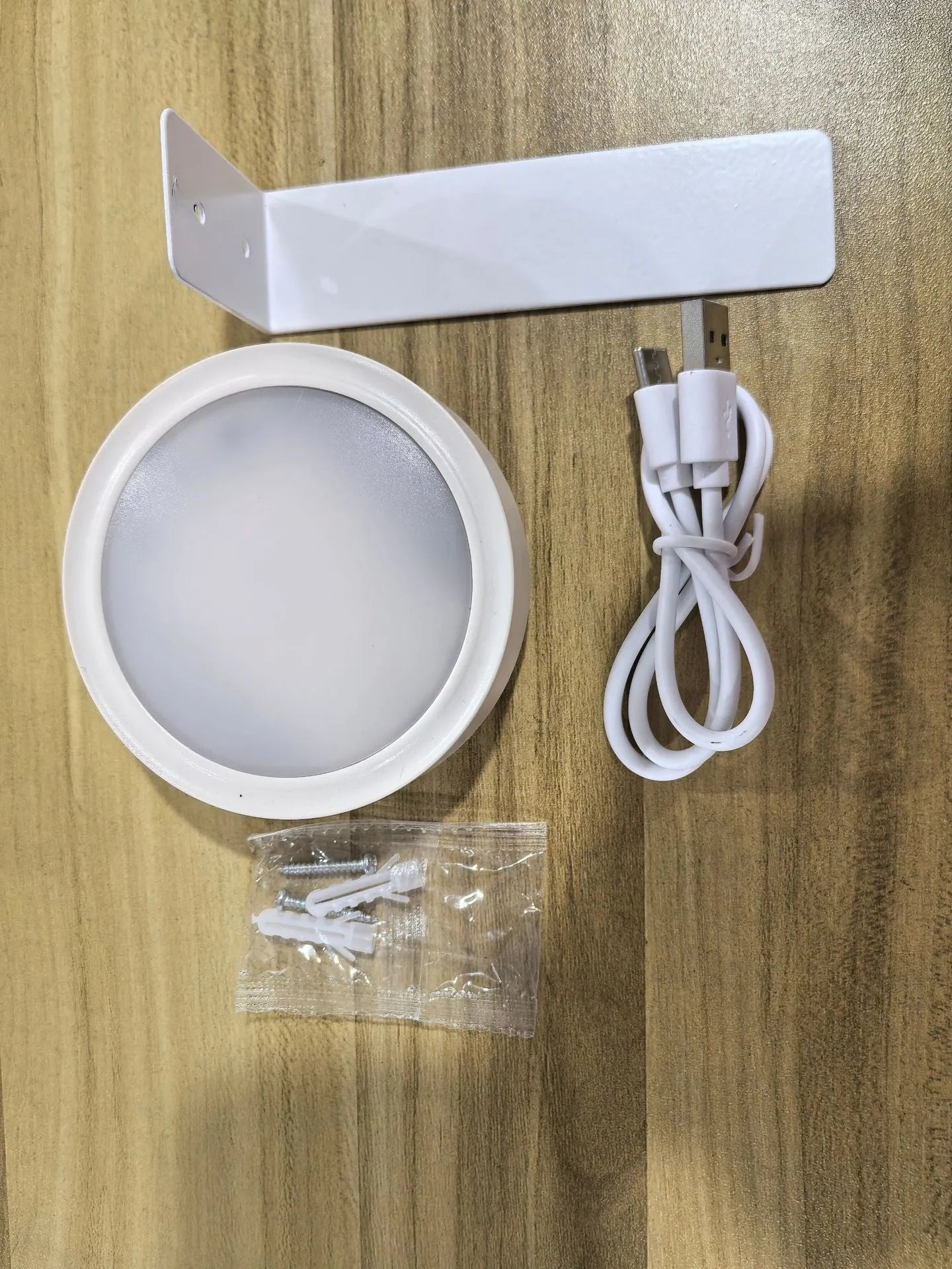 Wireless LED painting lamp with a magnetic mounting belt and remote control in black finish.