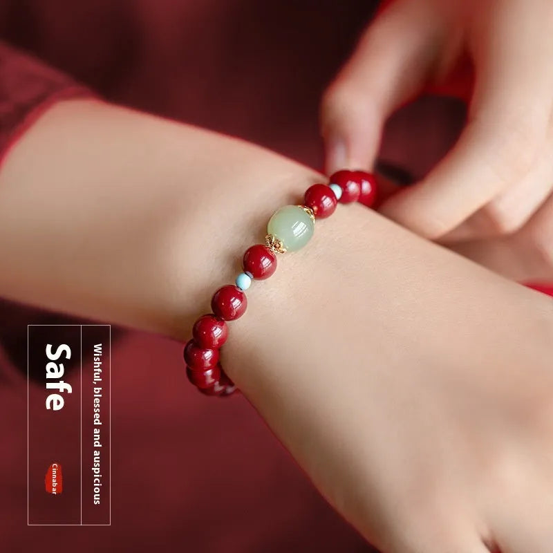 Purple gold sand cinnabar bead bracelet with geometric ellipse shapes on a wrist.