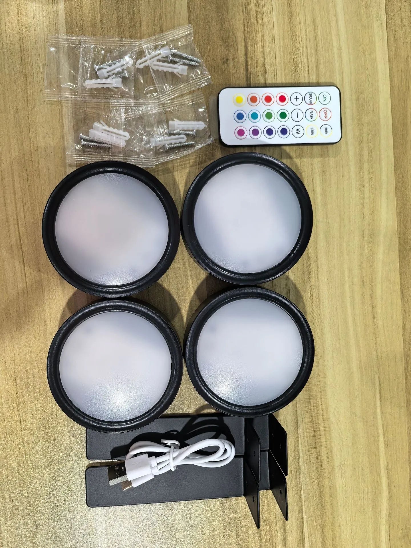 Wireless LED painting lamp with a magnetic mounting belt and remote control in black finish.