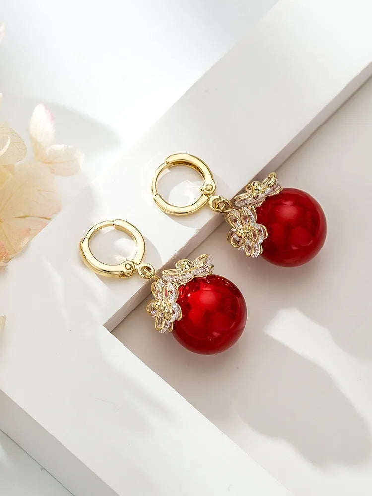 A pair of simple geometric rose-inspired earrings for women, made from electroplated copper, shown in one of the available colour types.
