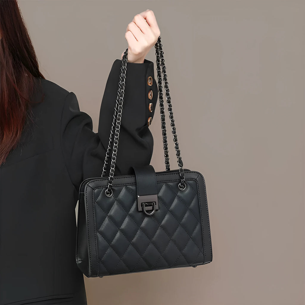 Women's black genuine leather chain crossbody square bag, soft underarm handbag on model