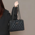 Women's black genuine leather chain crossbody square bag, soft underarm handbag on model