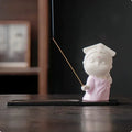Ceramic cute female court attendant figurine incense burner decoration on a surface.