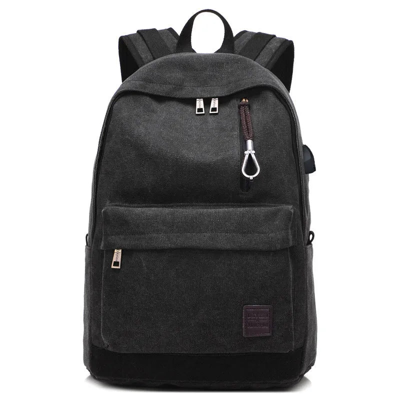 Canvas backpack with USB charging port showing laptop compartment and multiple pockets