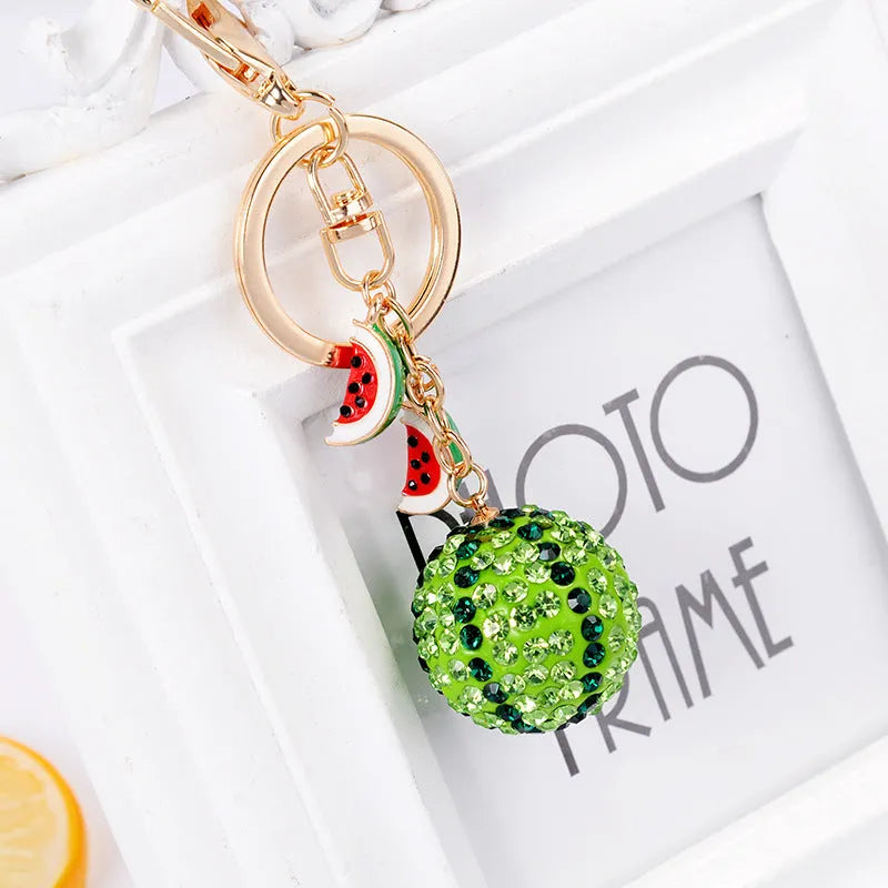 Green zinc alloy watermelon keychain measuring 12 cm in length.