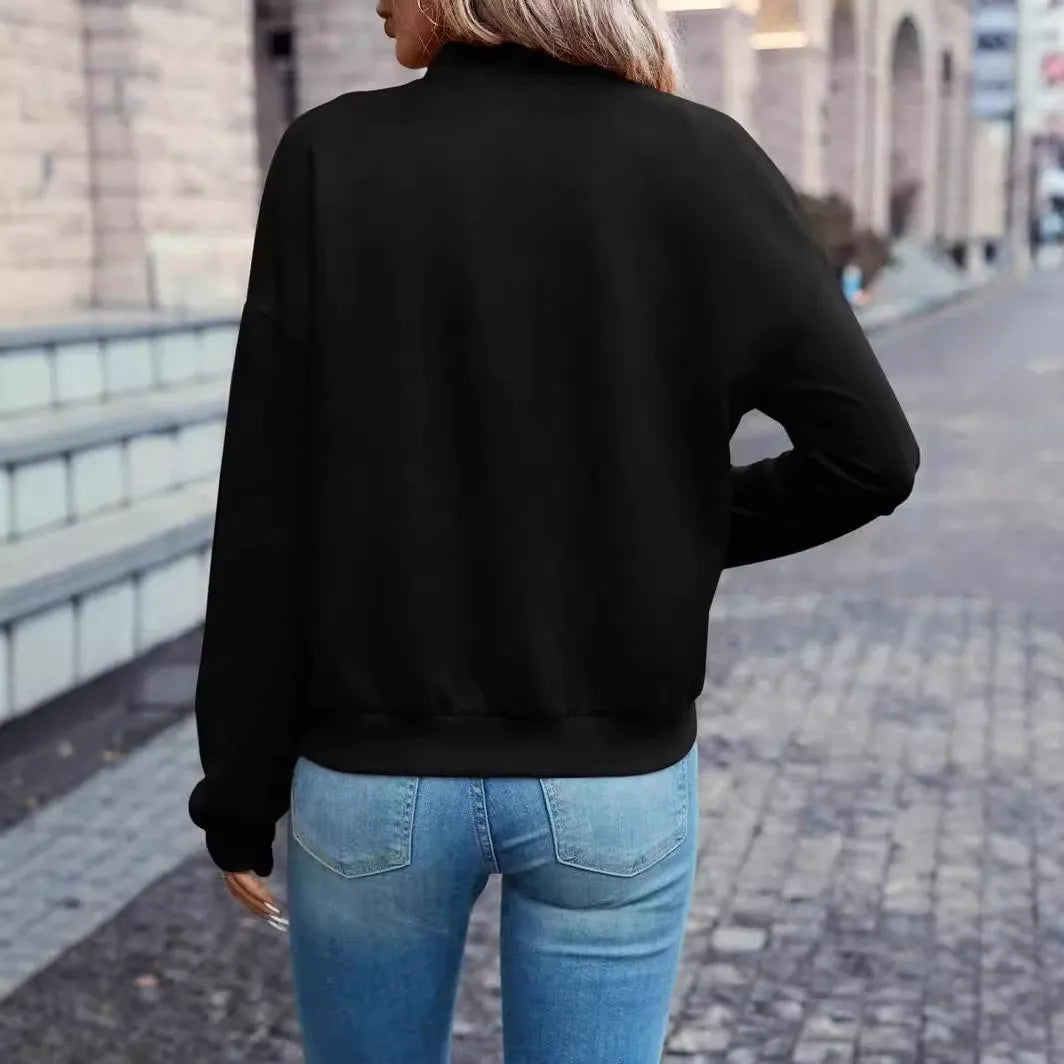 Black women's casual zip-up jacket with long sleeves and faux pockets on a hanger.