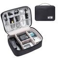 Black waterproof travel cable organiser bag open, showing mesh pockets, elastic loops, and removable padded dividers.
