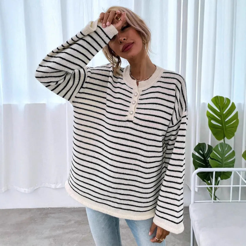 Black and white striped women's loose-fit long sleeve top with drop shoulders and button front.