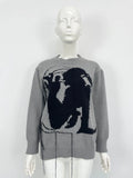 Women's grey alpaca wool sweater with tassel detailing and round neck.