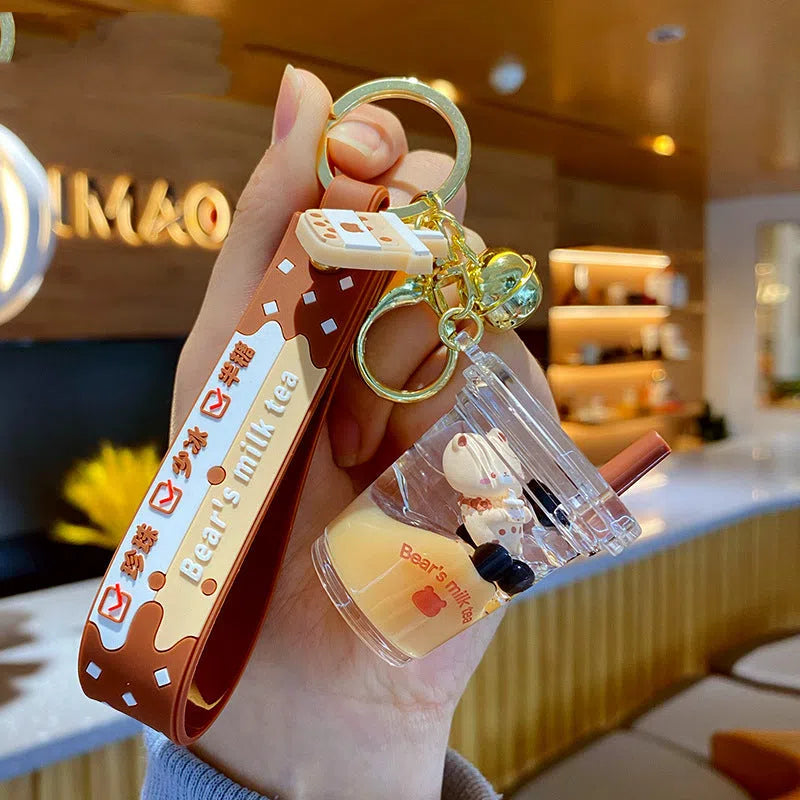 Oil-infused pearl milk tea bear keychain pendant in clear acrylic with alloy ring, featuring a drink bottle style design