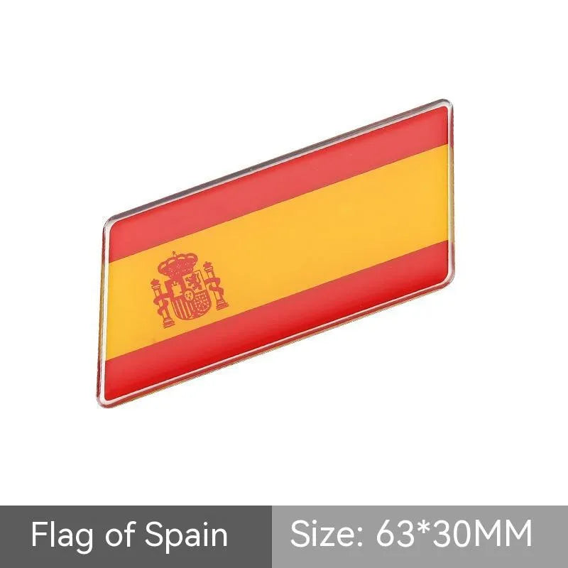 Aluminium parallelogram car sticker showing a national flag design, measuring 6.3 by 3 centimetres.