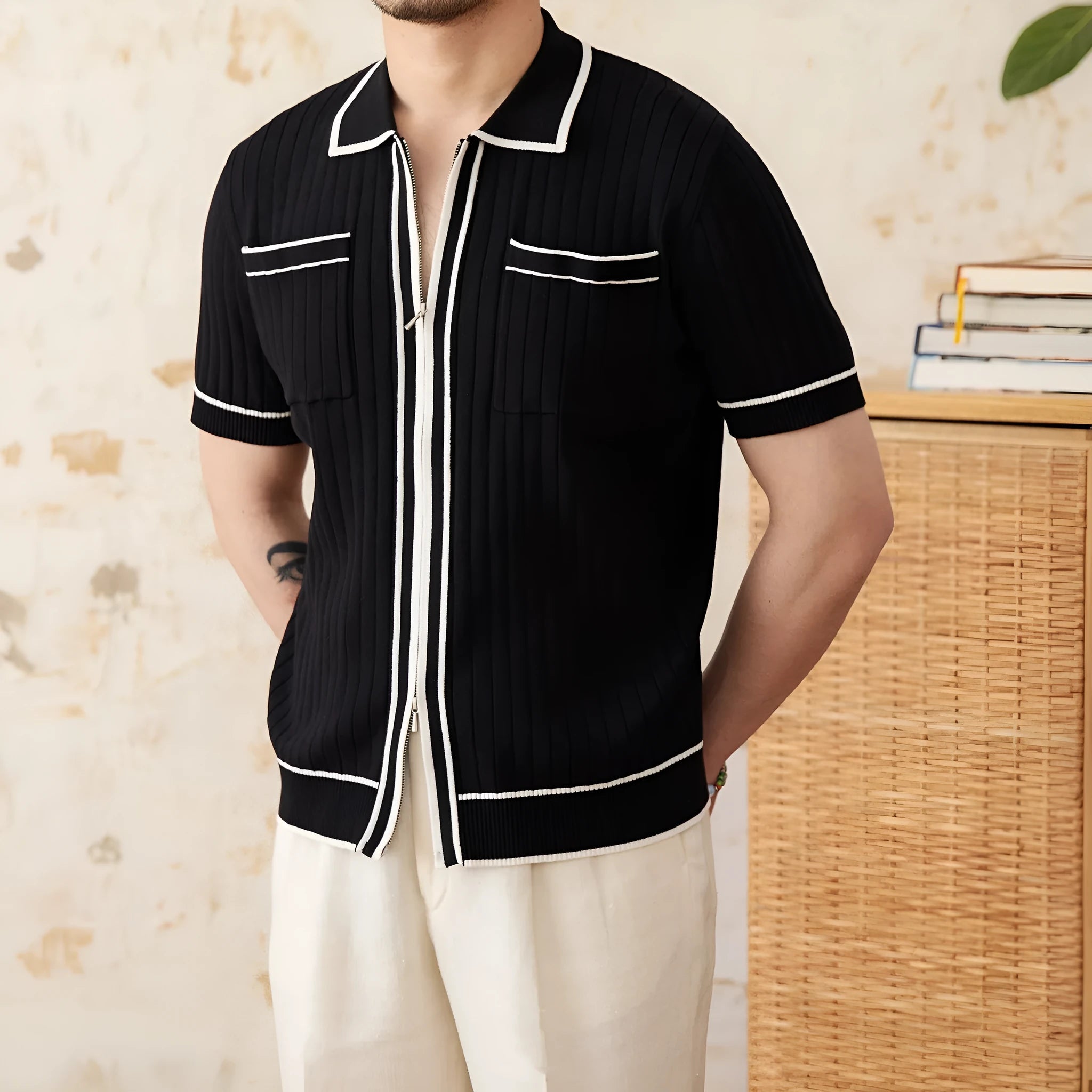 Slim black and white elastic knit polo shirt with lapel collar and short sleeves on hanger