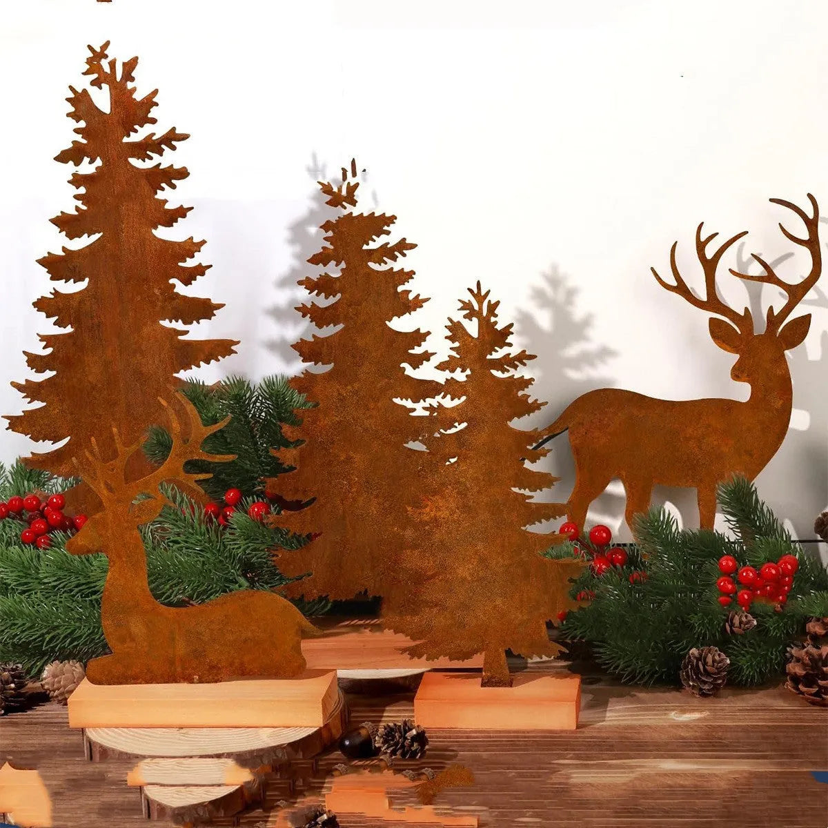 Set of three rusty iron elk and Christmas tree metal ornaments on a wooden surface.
