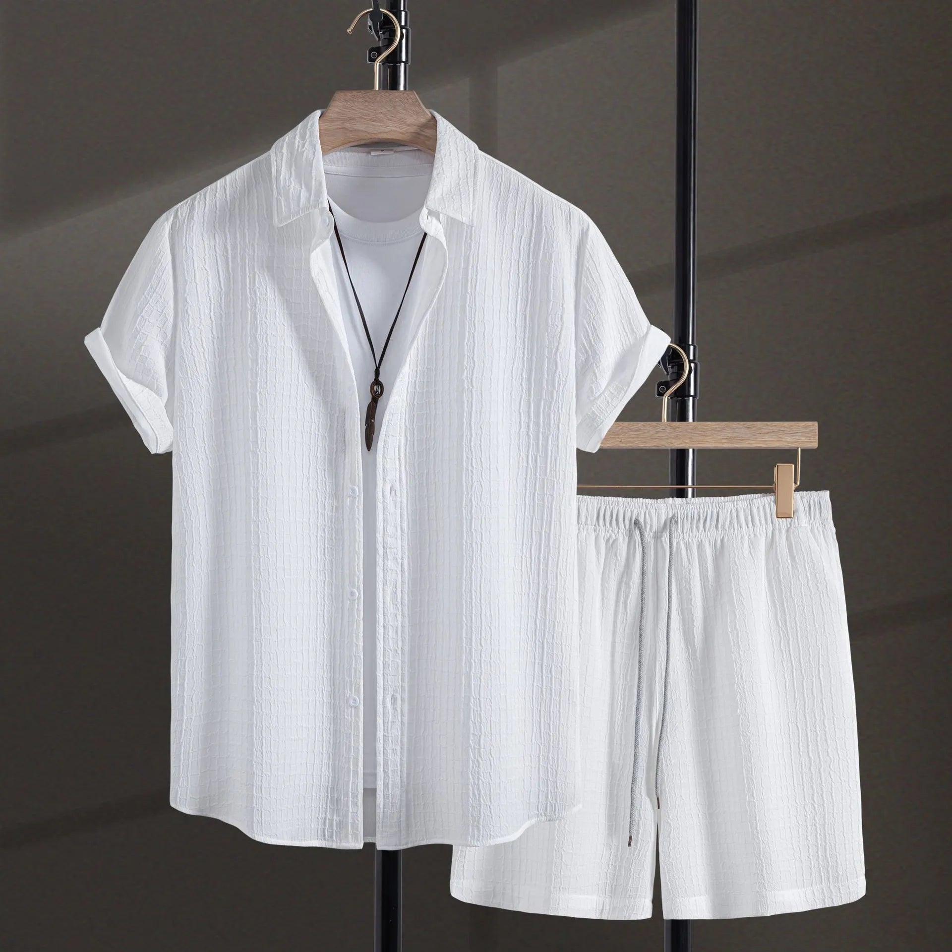 Men's white jacquard cotton blend short sleeve shirt and matching shorts laid flat.