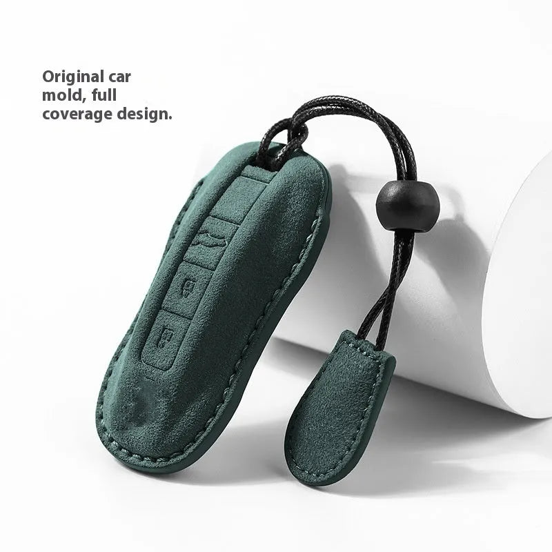 Suede car key cover in cement grey, dark green, light grey, and orange colour options.