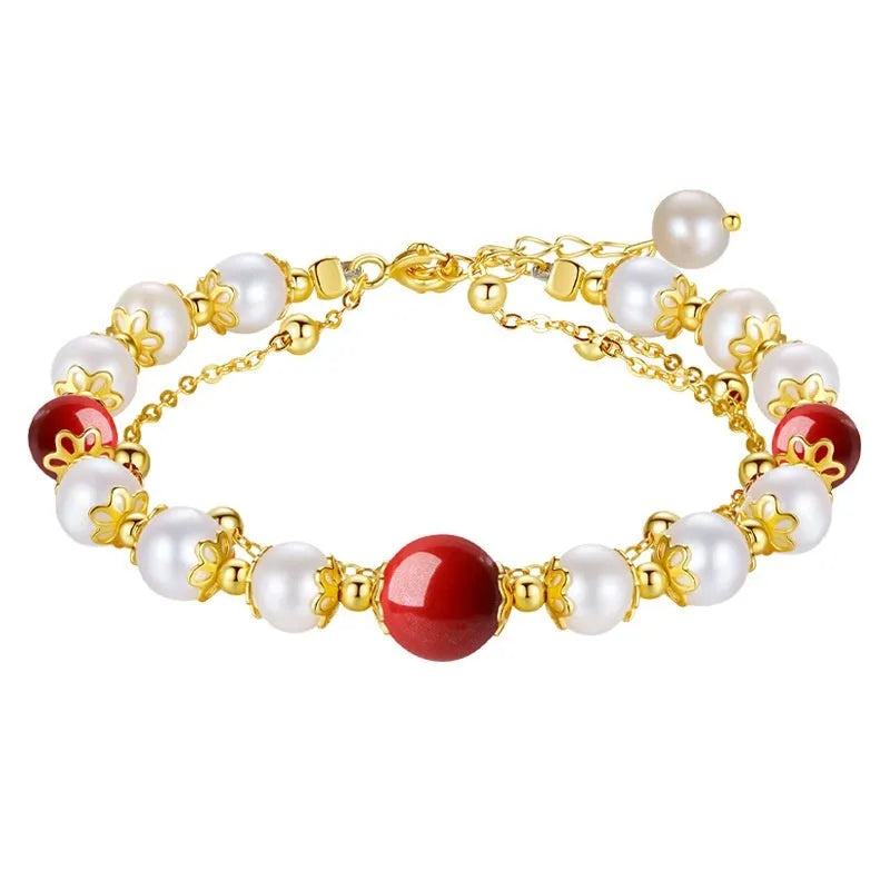 Sterling silver double-layer bracelet with cinnabar red bean and freshwater pearl beads, electroplated finish, geometric bean shape on white background