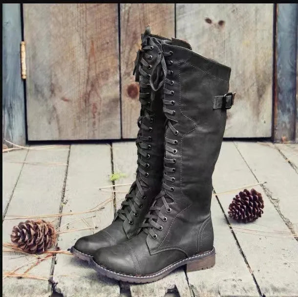 Women's black casual high leg boots with a chunky low heel and round toe on a plain background