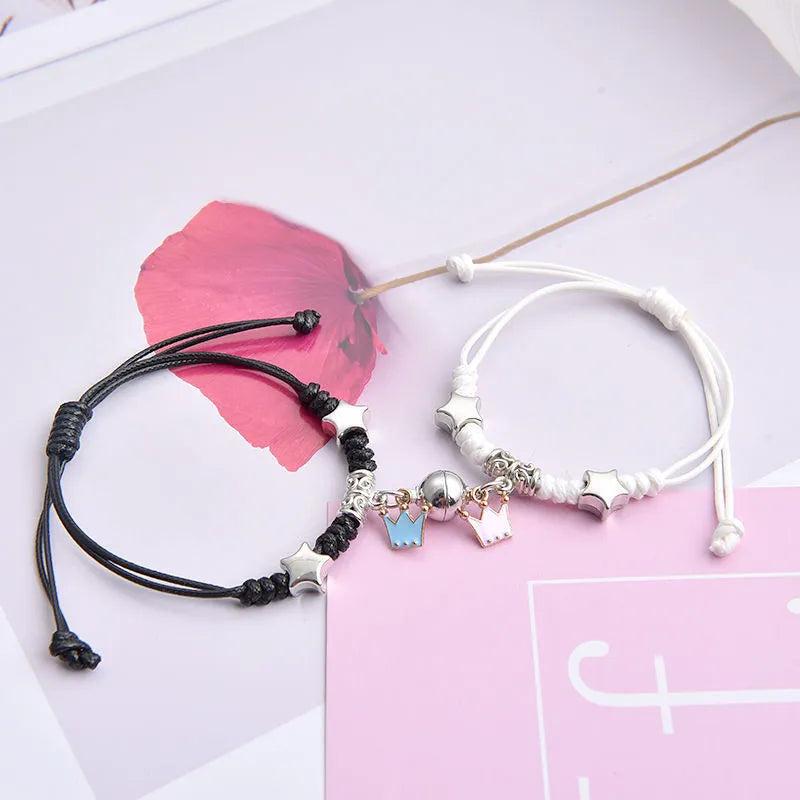 Magnetic clasp couple bracelets with alloy construction and symbolic designs including crown and love lock motifs.