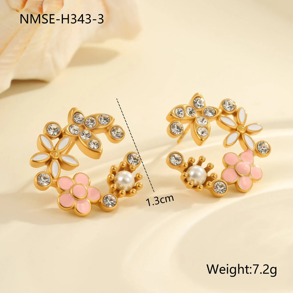 Close-up of colourful oil finish flower-shaped stud earrings with petal details on a stainless steel post.