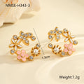 Close-up of colourful oil finish flower-shaped stud earrings with petal details on a stainless steel post.