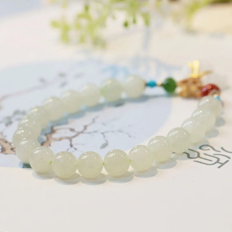 8mm natural Hetian gray jade round bead bracelet on women's wrist, retro style