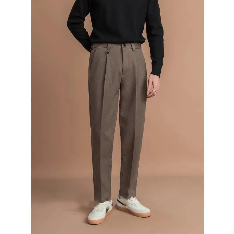 Man wearing grey straight leg polyester trousers for a smart casual look.