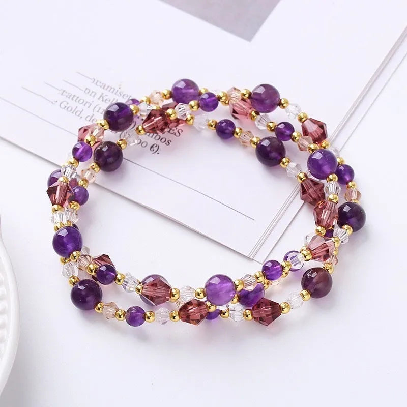 Women's adjustable bracelet with tourmaline, strawberry quartz, or amethyst crystal beads on a cord.