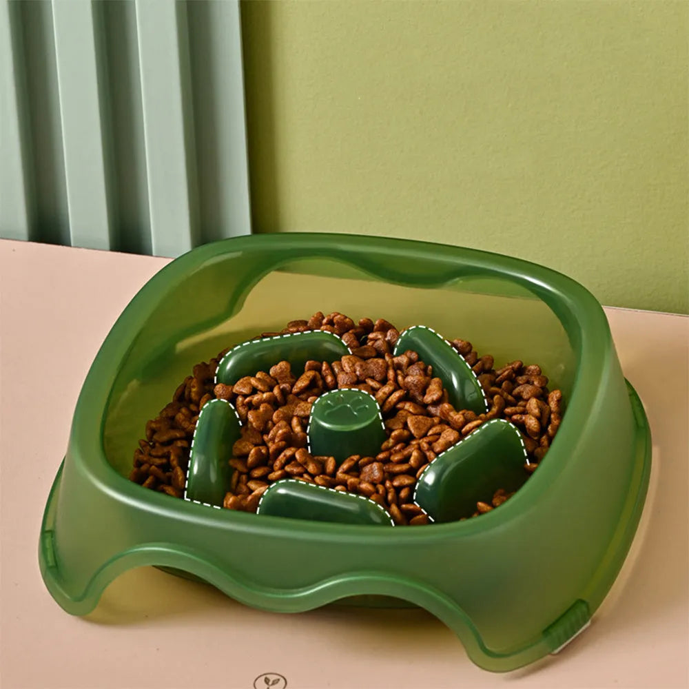Blue plastic slow feeder dog bowl for anti-choking feeding on a plain surface.