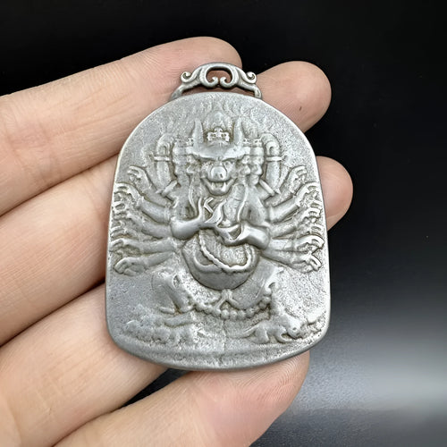 Close-up of a Chinese style iron wall pendant with geometric designs and Yamantaka figure.