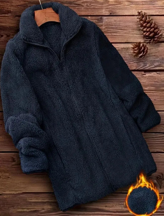 Man wearing a black double-sided fleece jacket outdoors, showing soft texture.