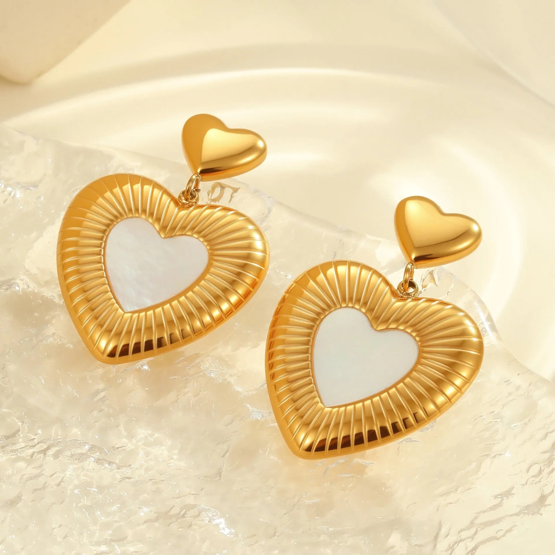 Gold electroplated heart-shaped earrings on stainless steel backing for women's fashion wear