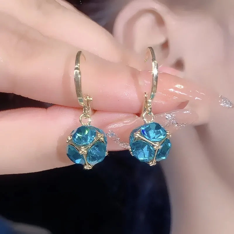 A pair of simple geometric rose-inspired earrings for women, made from electroplated copper, shown in one of the available colour types.