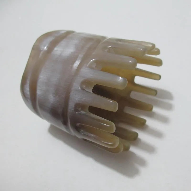 White buffalo horn meridian massage comb showing four different combing surfaces