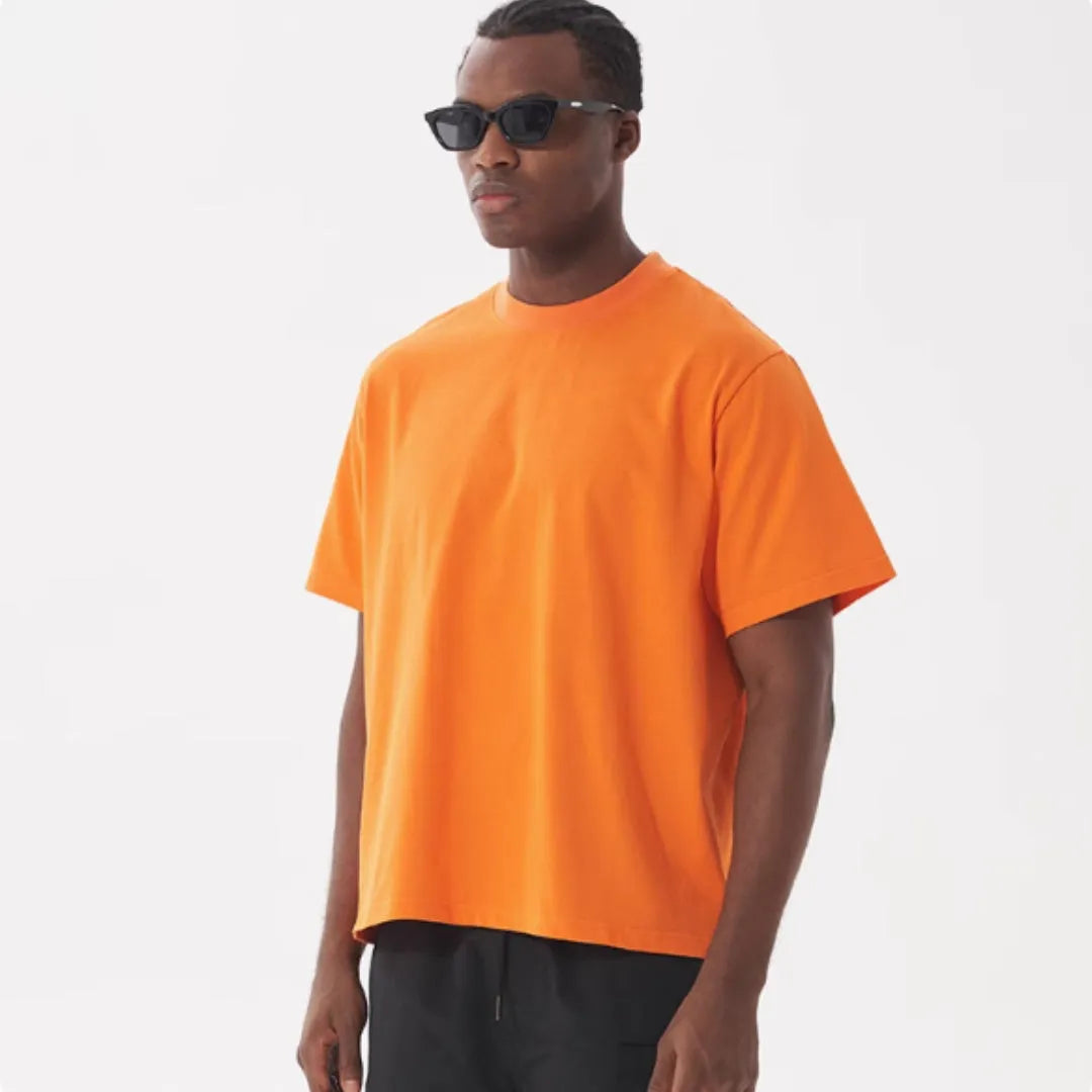 Pure cotton loose fit short sleeve t-shirt in apricot colour on a hanger.