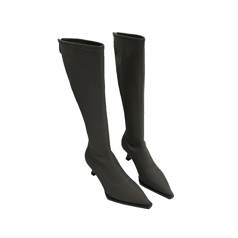 Black women's knee-high pointed toe boots with a stiletto heel and back zip fastening.