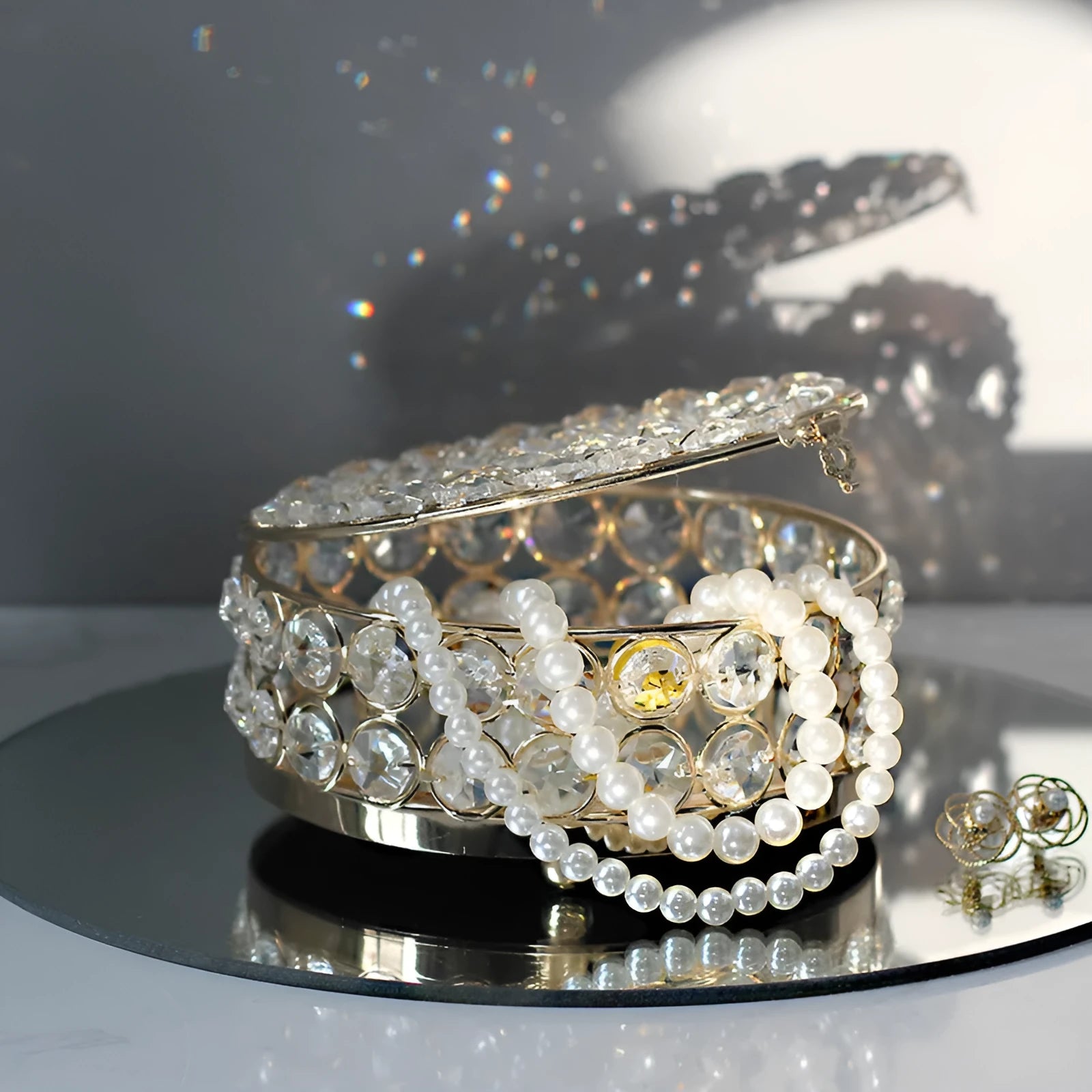 Transparent crystal glass jewellery storage box with French gold metal finish in a European style.