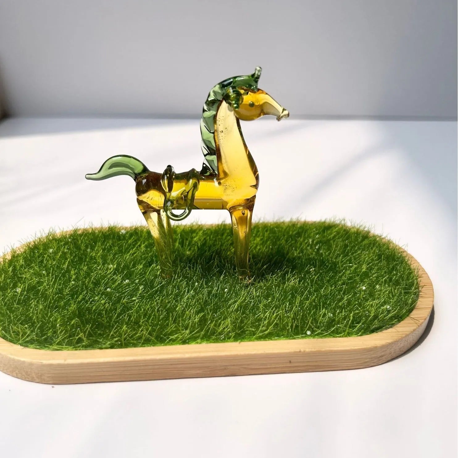 Glazed brown horse figurine on wooden desk as office decoration