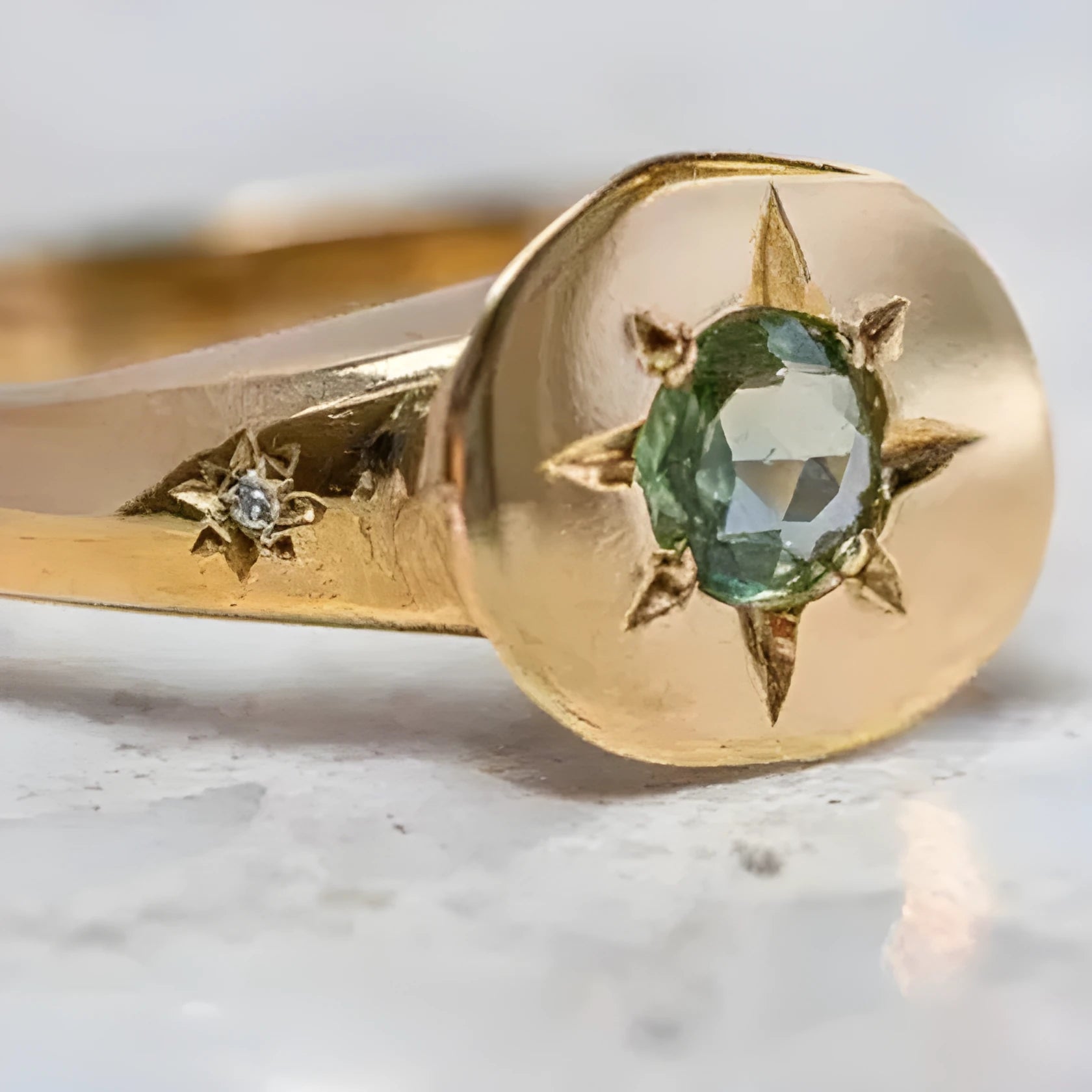 Golden oval ring with a star design and adjustable opening.