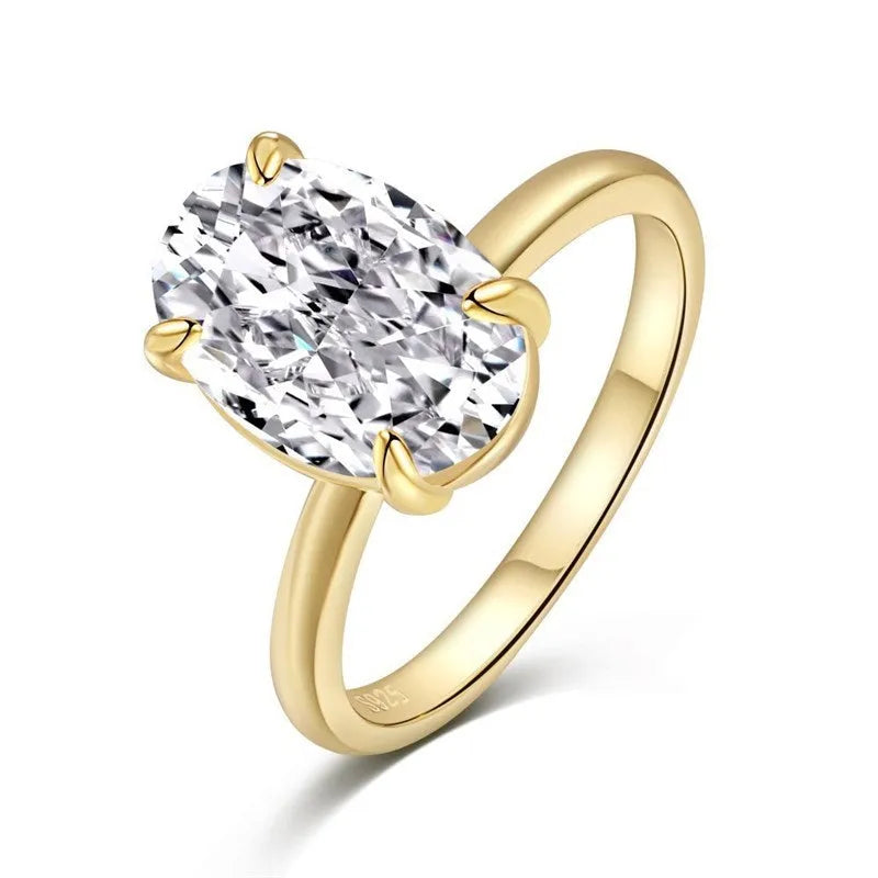 Women's oval four-claw solitaire ring with 6x9mm gemstone in gold or silver finish