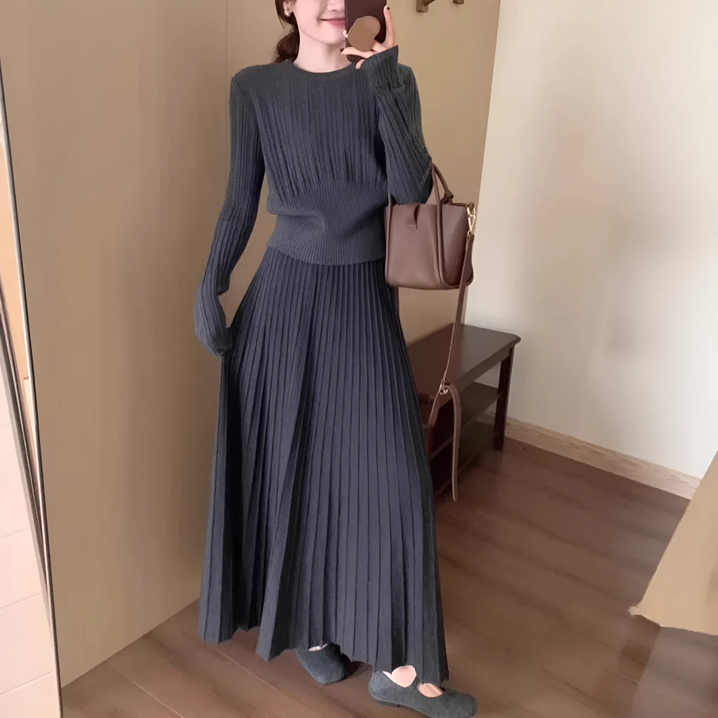 Dark grey knitted two-piece suit with 3D textured patterns, showing sweater and matching skirt