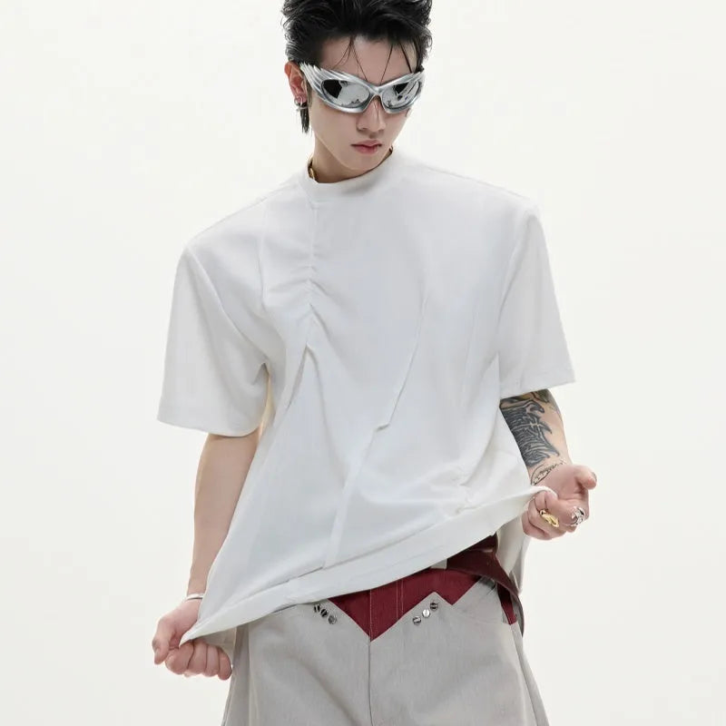 Man wearing a black cotton t-shirt with textured 3D pleating and a round neck