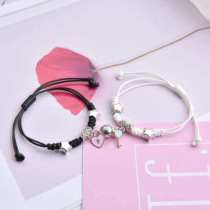 Magnetic clasp couple bracelets with alloy construction and symbolic designs including crown and love lock motifs.